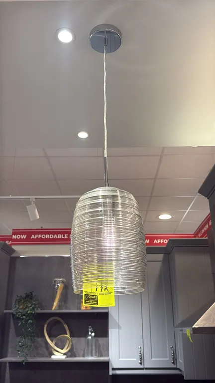 Glass pendant hanging lights. Features textured ribbed clear glass shades, cord suspension, and polished chrome-finish round ceiling canopies. Ceiling
