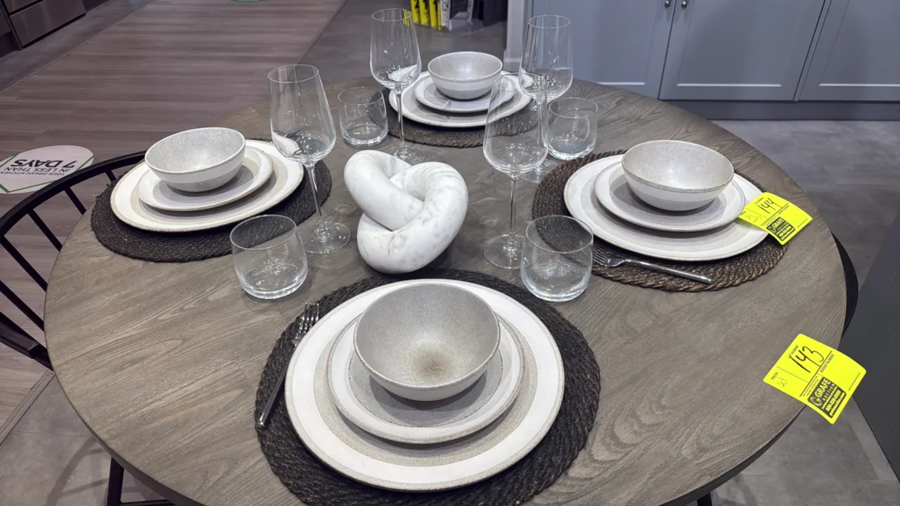 Assorted kitchen and dining smallwares and decor. Includes ceramic dinnerware place settings (plates, bowls), wine glasses, tumblers, woven placemats,