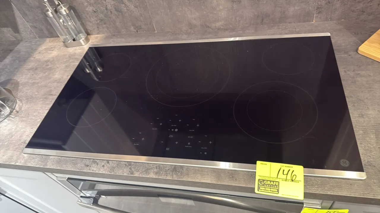 GE 5-burner drop-in electric cooktop. Features smooth black ceramic glass surface with stainless steel trim, 5 radiant heating elements including tri-