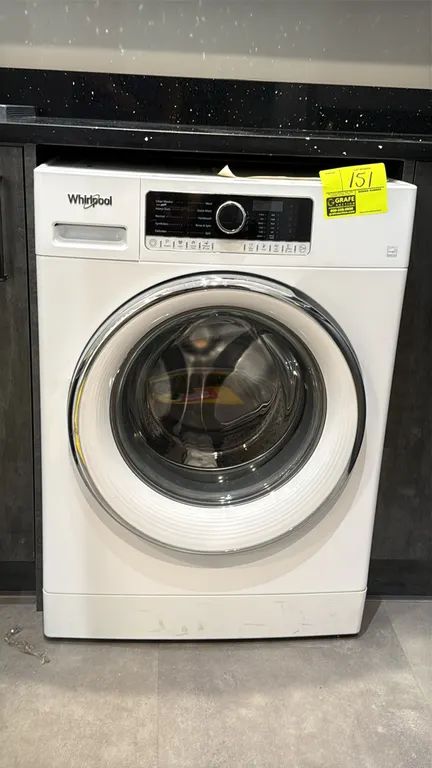 Whirlpool WFW5090JW front load washer. Features stainless steel drum, pull-out dispenser drawer, and digital controls with cycle selection dial. S/N: