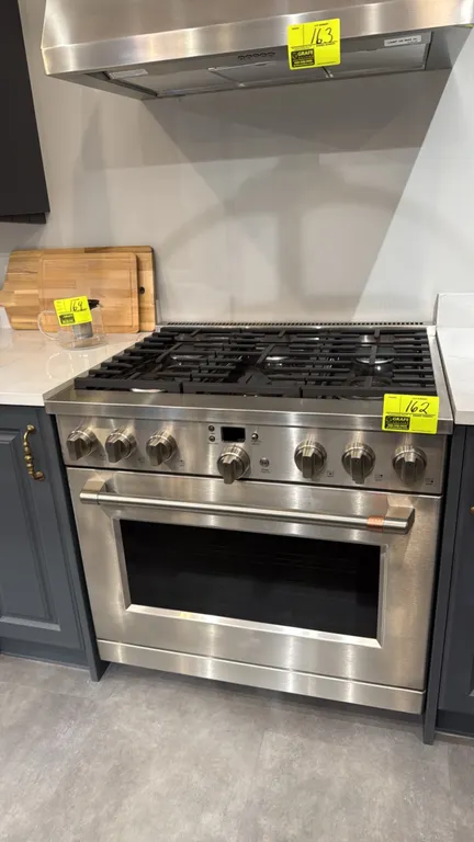 Café CGY366P2T1S1 36" freestanding 6-burner gas range. Features stainless steel finish, continuous cast iron grates, convection oven with 3 interior r