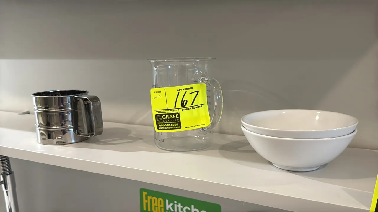 Assorted kitchen smallwares and decor. Includes stainless steel flour sifter, glass measuring pitcher, ceramic bowls, glass canisters with lids, swing