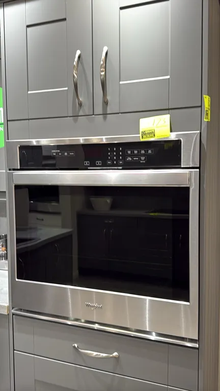 Whirlpool built-in electric wall oven. Features stainless steel finish, digital touch control panel, glass viewing window, and (2) interior wire racks