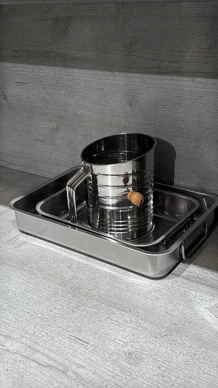 Assorted kitchen smallwares and serving ware. Includes wooden cutting board, (2) wooden serving boards, (2) glass decanters/bottles, (2) stainless ste