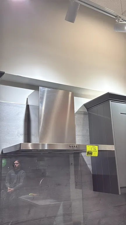Whirlpool WVW57UC0FS3 30" wall-mount chimney range hood. Features stainless steel construction, push-button controls, dual cooktop lights, and removab