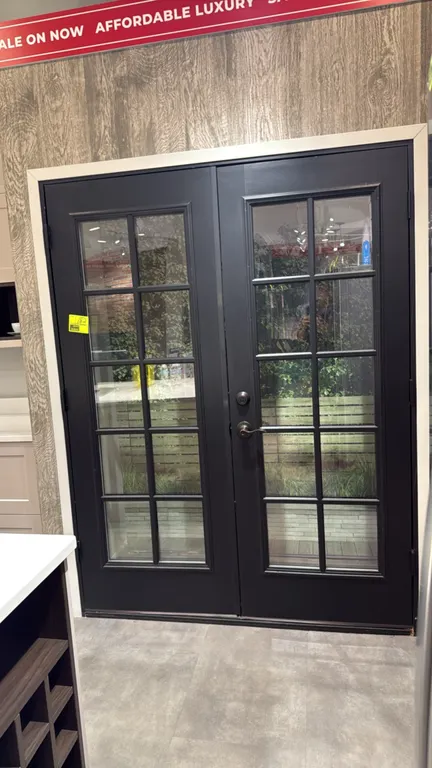Double French doors with frame. Features matte black finish and 10-lite clear glass panel inserts. Includes lever handle and deadbolt hardware. 62" x