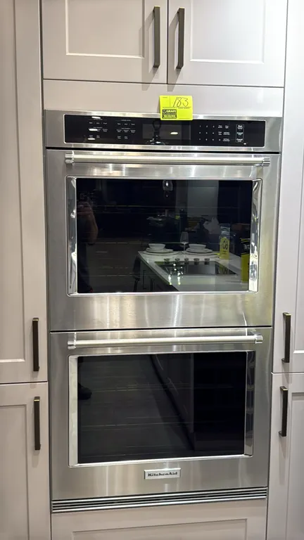 KitchenAid KODE500ESS20 30" built-in double oven. Features stainless steel finish, convection cooking modes, digital touch controls, and blue porcelai