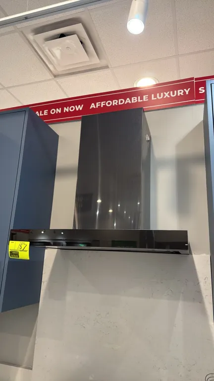 GE UVW9301BLTS wall-mount chimney range hood. Features stainless steel finish, integrated LED lighting, and electronic controls. 30"W. S/N: FT804588A.