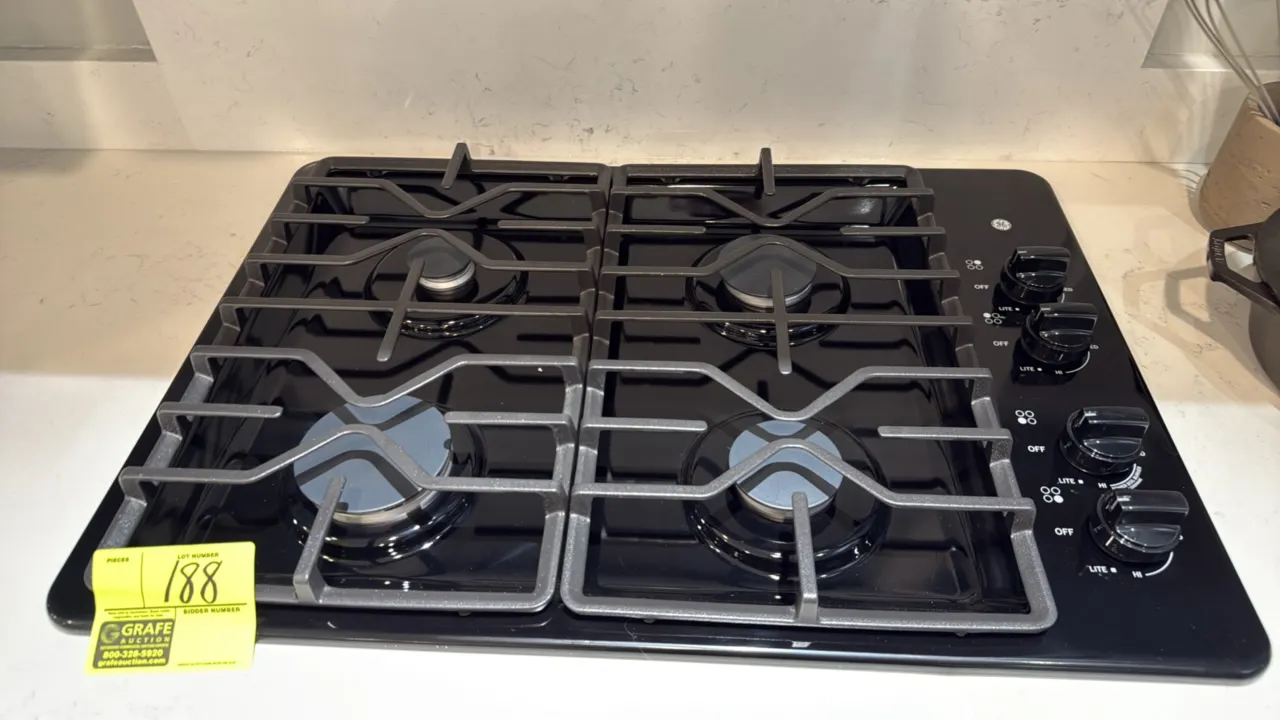 GE JGP3030DL1BB 4-burner built-in gas cooktop. Features black finish, cast grates, and right-side dial controls with Power Boil burner. 30"W. S/N: GT0