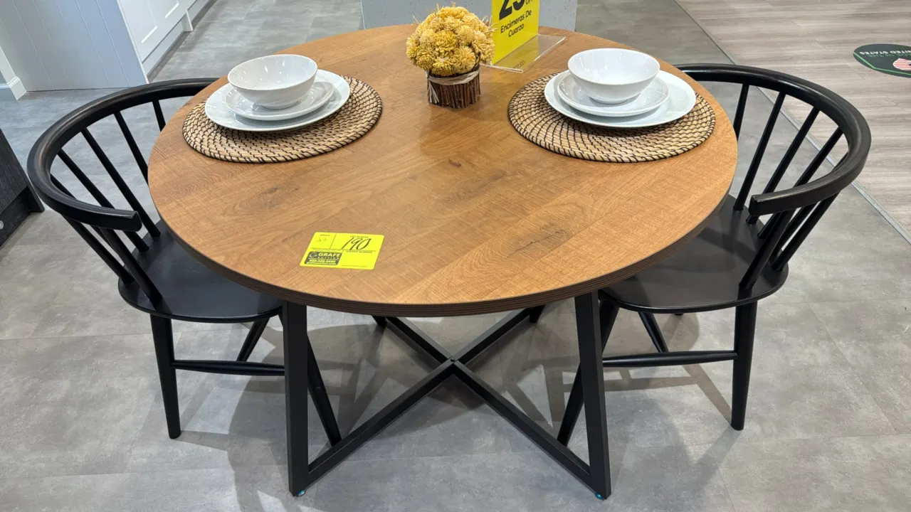 Dining table with (2) chairs. Features a round wood top on a black metal base, paired with (2) black wood spindle-back chairs. Dimensions: 41"Dia. Pla