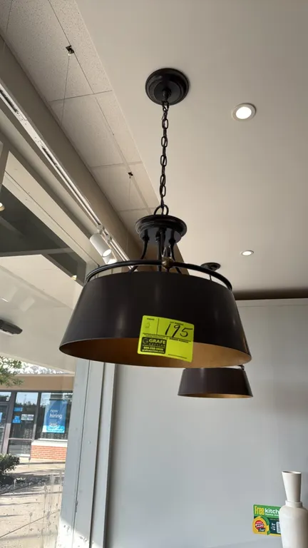 Metal hanging pendant lights. Features dark bronze-tone finish, warm metallic interior shade lining, and a 3-light socket cluster. Suspended by chain