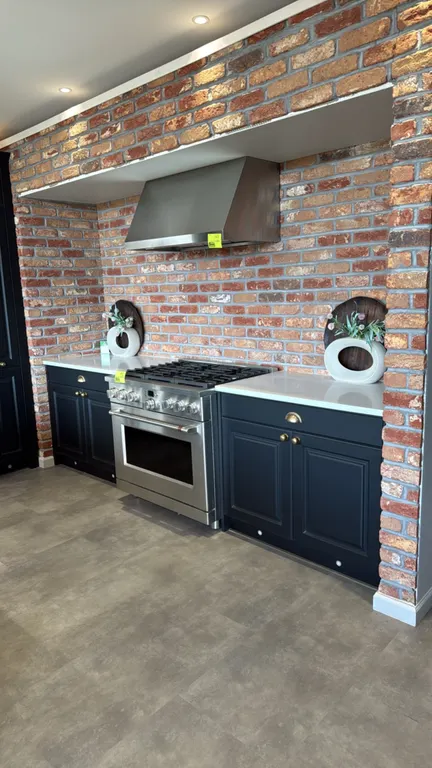 Infinity Plus kitchen cabinets. Features quartz countertops, apron-front sink, faucet, 98" x 40" peninsula cabinets, 73" x 98.75"H wall cabinets, (2)