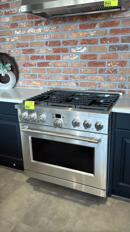 Café CGY366P2T1S1 36" smart commercial-style all-gas range. Features 6 burners, continuous cast-iron grates, oven with racks, stainless steel finish,