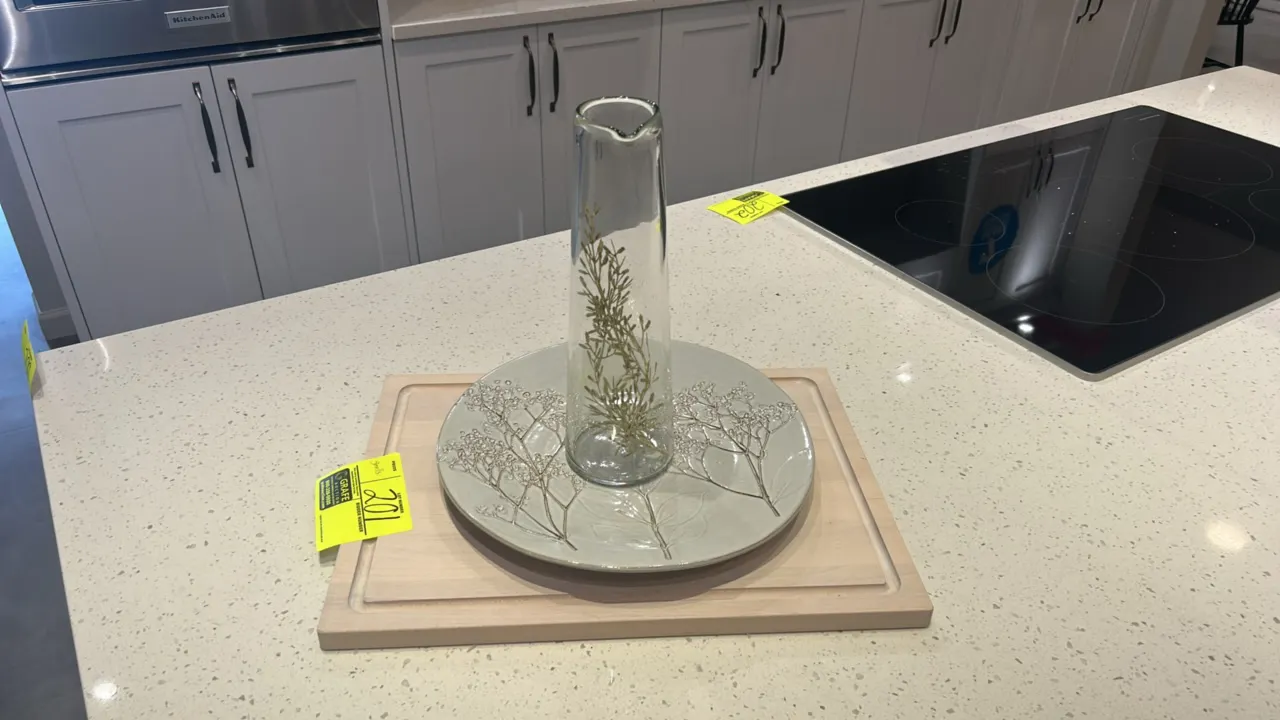 Assorted kitchen and decorative smallwares. Includes (2) wood cutting boards, (1) ceramic decorative platter with botanical motif, (1) clear glass car