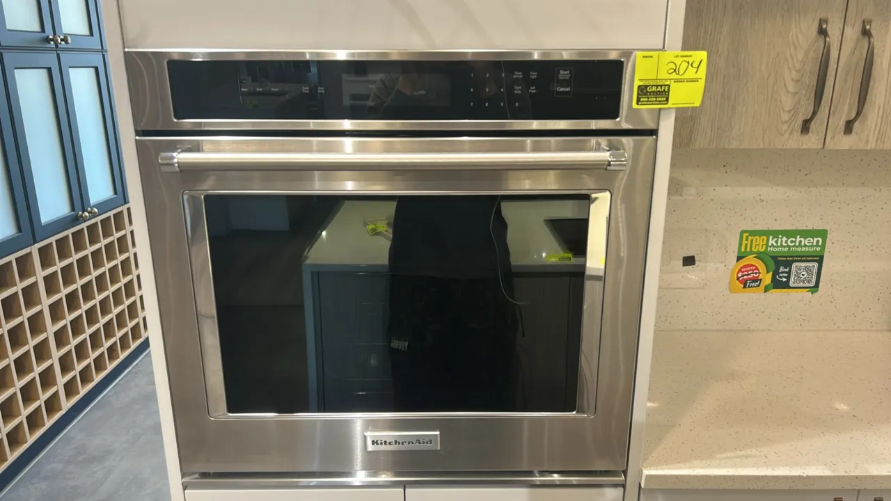 KitchenAid KOST100ESS04 built-in single electric wall oven. Features stainless steel finish, digital touch controls, and blue porcelain interior with