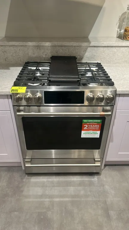 Café CGS700P2M3S1 30" slide-in gas range. Stainless steel construction with 6-burner cooktop, center cast iron griddle, convection oven with 3 racks,