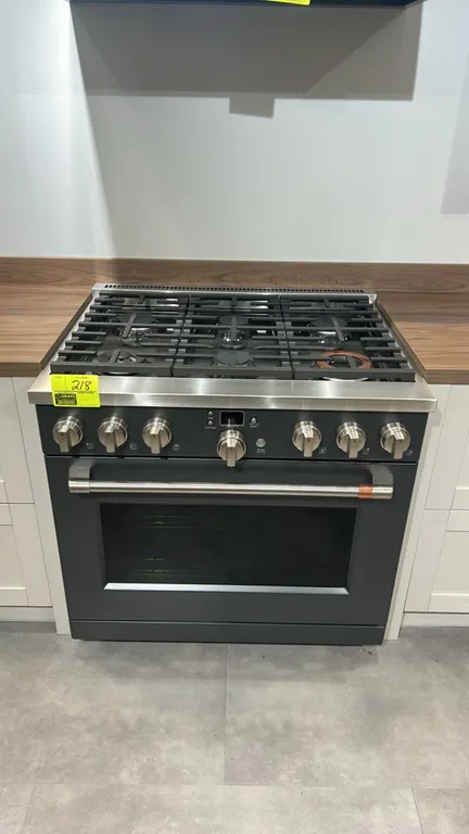 Café CGY366P3T1D1 36" commercial-style smart dual-fuel 6-burner range. Features continuous cast-iron grates, matte black finish with stainless steel a