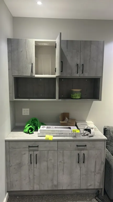 Infinity Plus laminate cabinet set. Features gray woodgrain finish, laminate countertop, upper wall unit with (4) cabinet doors and (2) open cubbies,