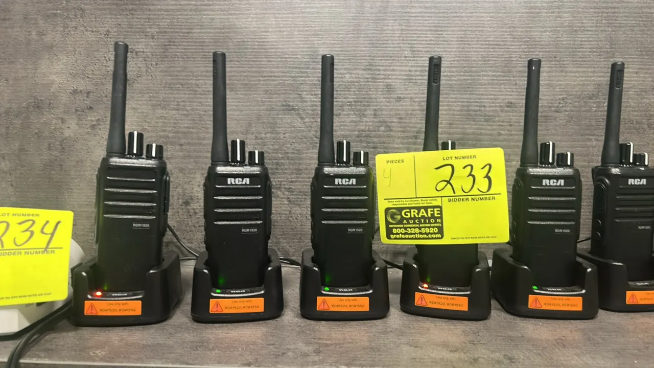 RCA RDR1520 two-way radios. Features top channel and volume control knobs, integrated speakers, and flexible antennas. Includes desktop charging cradl