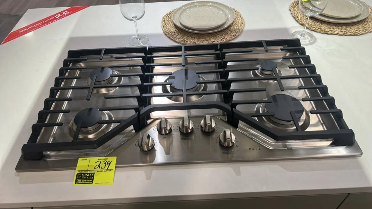 Café 36" 5-burner gas cooktop. Features stainless steel construction, continuous cast iron grates, front-mounted control knobs, and power boil burners