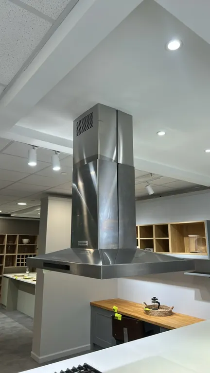 KitchenAid KVIB606DSS4 stainless steel island-mount canopy range hood. Features chimney flue cover, front digital touch controls, and integrated under