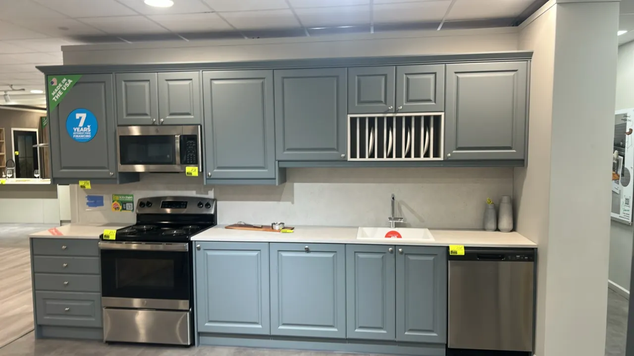 Infinity Plus laminate kitchen cabinets. Features laminate countertop, upper and lower cabinetry, integrated upper plate rack, BOCCHI drop-in sink, an