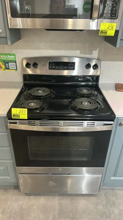 GE JB256RM2SS 30" freestanding electric range. Features stainless steel exterior, 4 coil burners, self-clean oven with window, interior racks, and bot