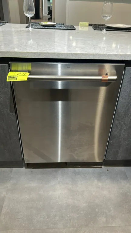 Café CDT805P2N4S1 built-in household dishwasher. Features stainless steel exterior, top control panel, bar handle with copper accent, stainless steel