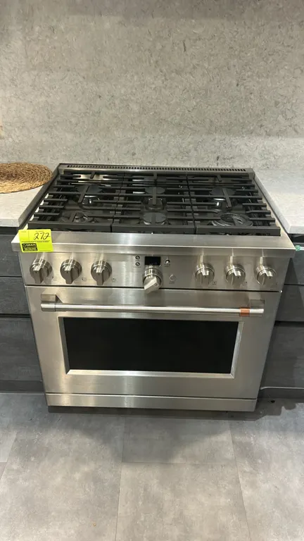 Café C2Y366P2T1S1 36" smart commercial-style range. Features stainless steel construction, 6 gas burners with continuous cast iron grates, digital dis