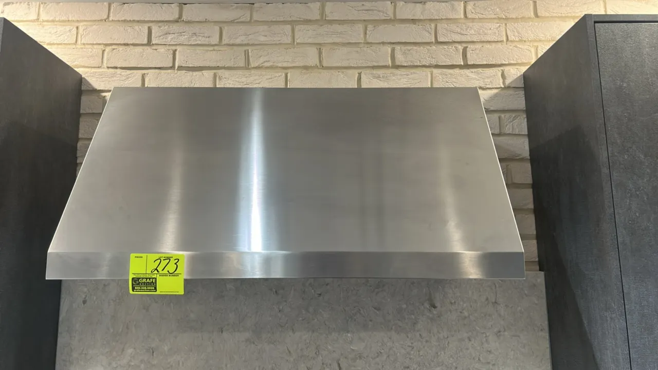 Café commercial-style kitchen range hood. Features stainless steel construction, baffle filters, push-button controls, and integrated lighting. 36"W.