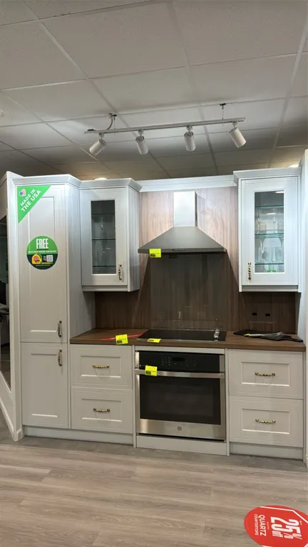 Infinity Plus upper and lower kitchen cabinets. Features tall pantry cabinet with interior pull-out drawers, dual glass-front upper cabinets with glas