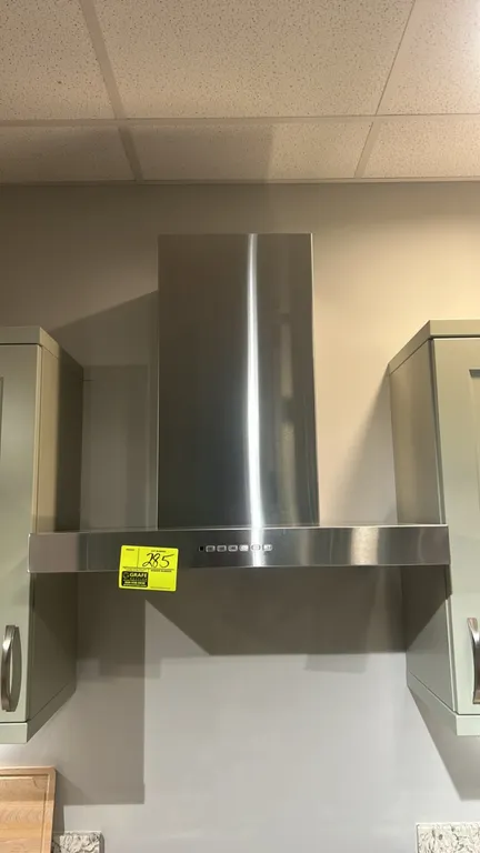 GE Appliances UVW8301SL2SS wall-mount range hood. Features stainless steel construction with chimney duct cover, dual mesh grease filters, push-button