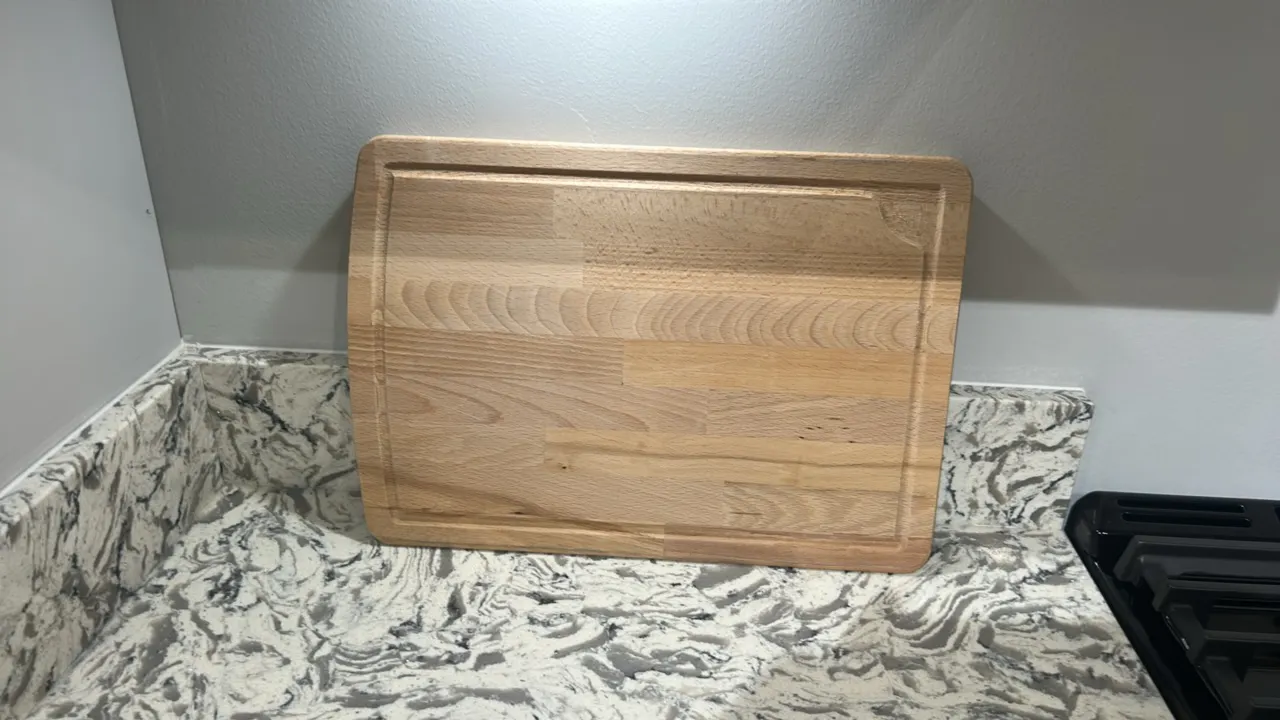 Assorted kitchen smallwares. Includes 2-tier metal wire dish drying rack with utensil basket, wooden cutting board with perimeter juice groove, wooden
