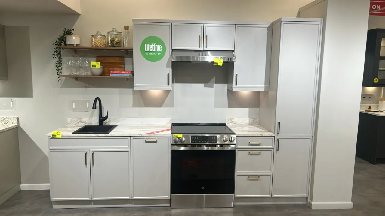 Infinity Plus laminate kitchen cabinets. Features faux-marble laminate countertops, upper and lower cabinetry, tall pantry unit, BOCCHI drop-in sink,