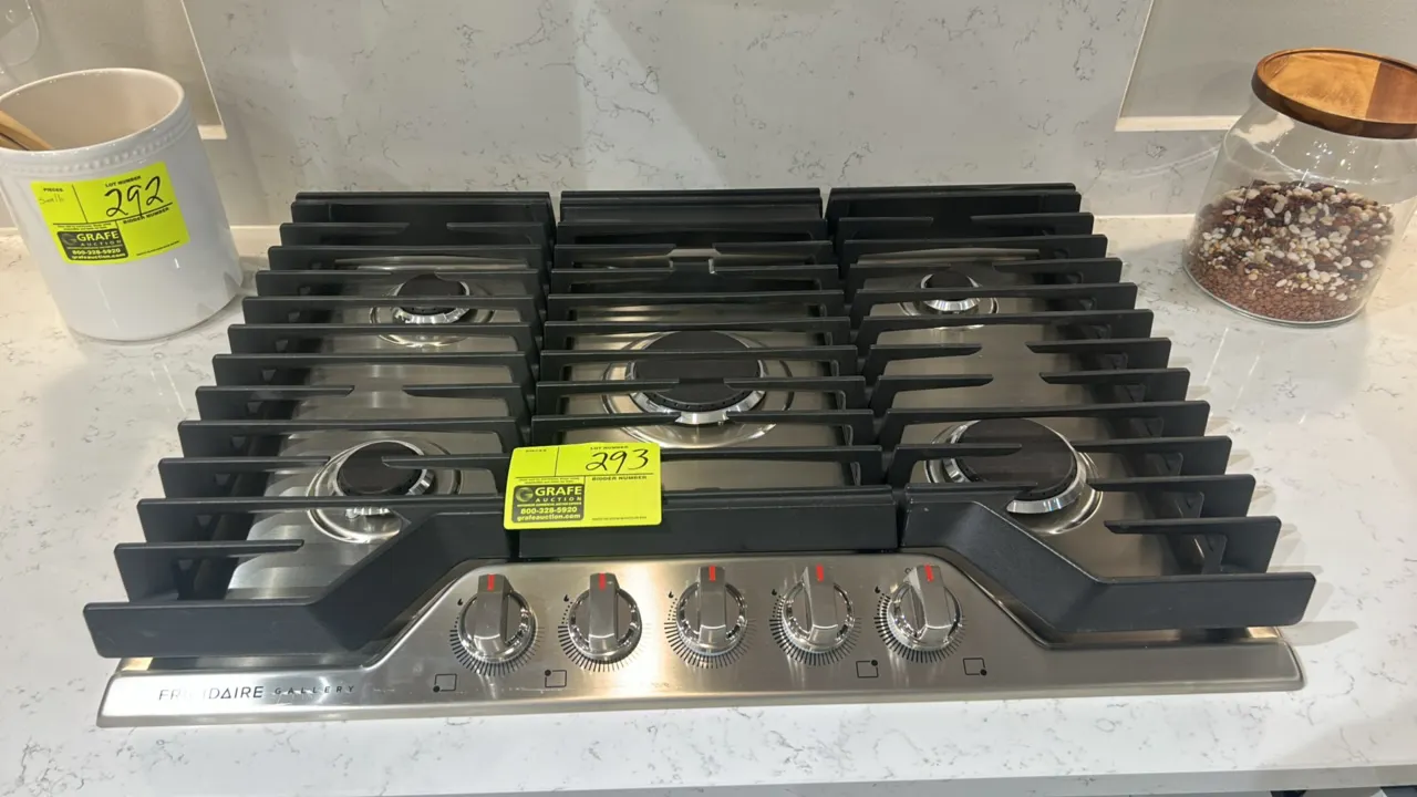 Frigidaire Gallery GCCG3048AS gas cooktop. Features stainless steel construction, 5 gas burners, cast iron continuous grates, and front control knobs.