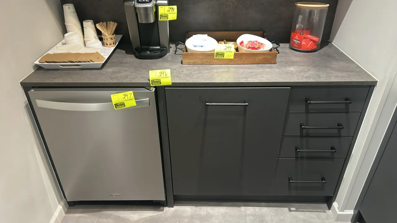 Infinity Plus laminate base cabinets. Features dark gray finish, stone-look laminate countertop, 4-drawer stack, single-door cabinet, and an undercoun
