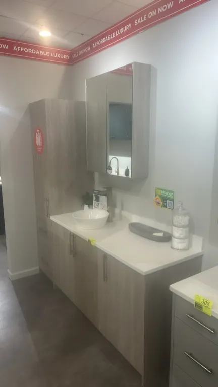 Infinity Plus laminate bathroom vanity cabinet set. Features solid surface countertop, tall linen cabinet, vanity base cabinet, vessel sink with fauce