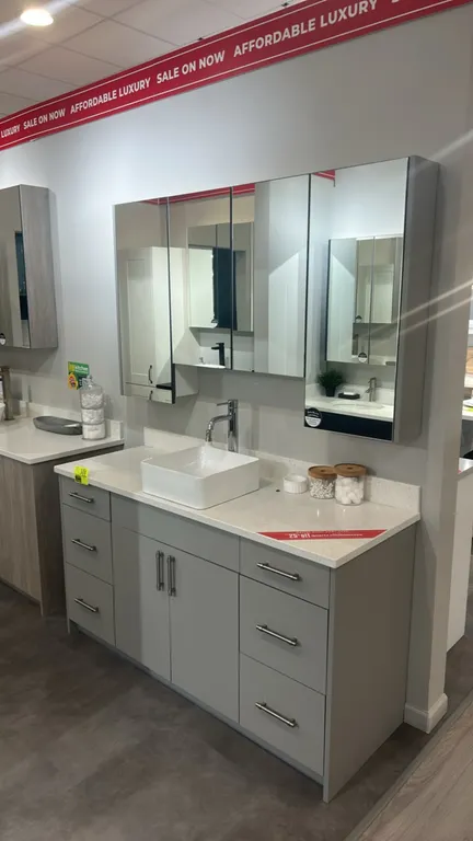 Infinity Plus bathroom vanity set. Features laminate base cabinet with 6 drawers and 2 center doors, solid surface countertop with backsplash, square