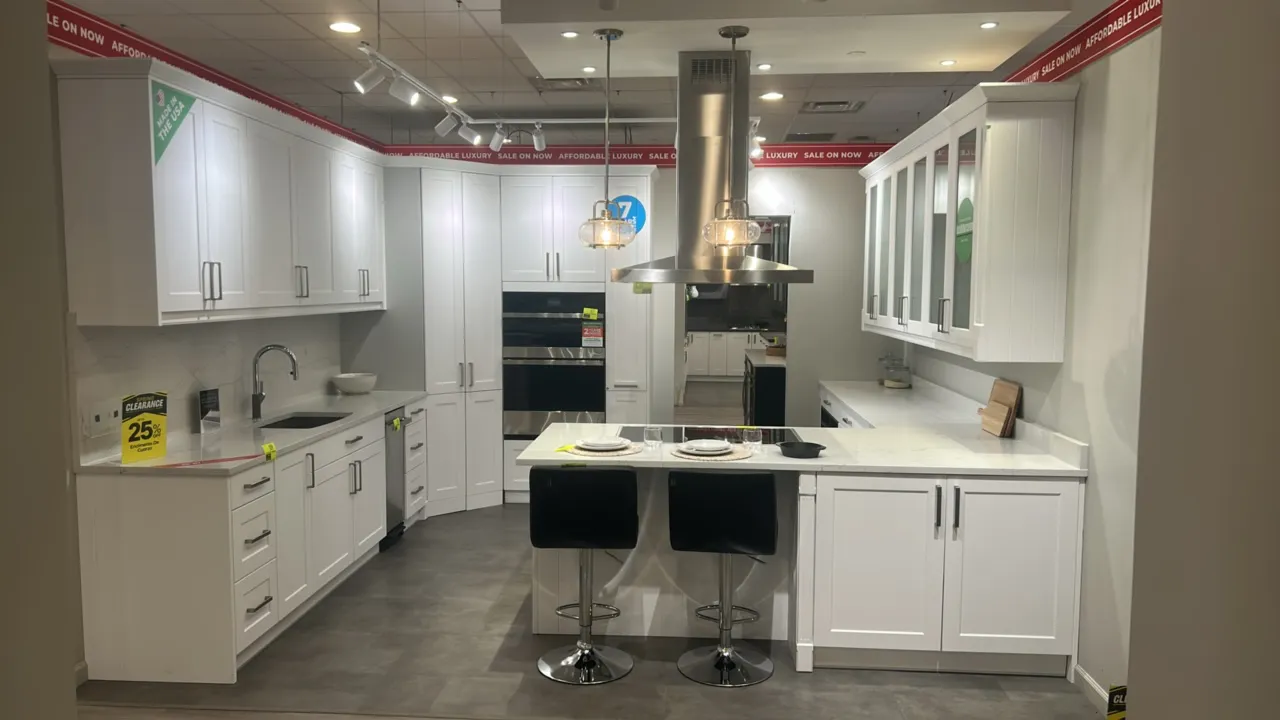 Infinity Plus laminate kitchen cabinets. Features quartz countertops, Blanco sink insert, stainless steel faucet, shaker-style cabinetry, and frosted