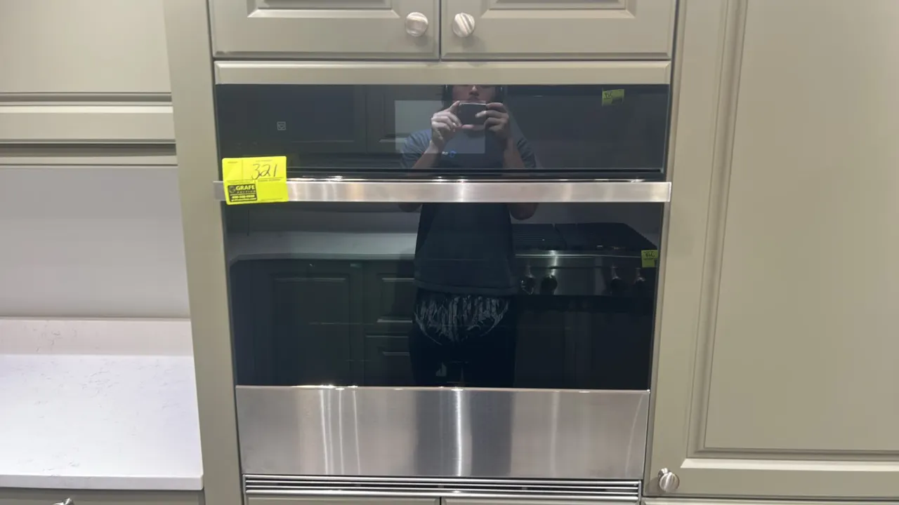 JennAir NOIR JJW3430LM00 single electric wall oven. Features stainless steel trim, digital display, drop-down glass door, and interior cavity with (3)