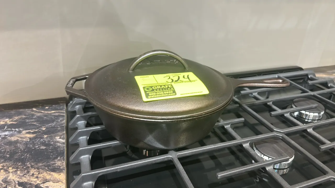 Lodge cast iron cookware and kitchen smallwares. Includes Lodge cast iron covered skillet with lid and white ceramic mixing bowl. Range and shelving n