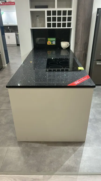 Infinity Plus laminate kitchen island cabinets. Features white laminate cabinetry, 4-drawer base unit, 2-door cabinet, metal bar pulls, and black spar
