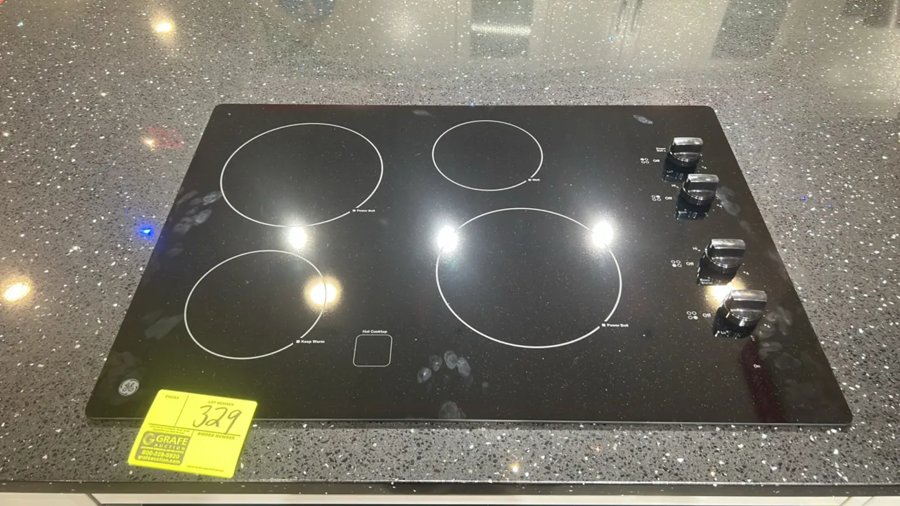 GE Appliances JP3030DJ4BB 4-burner radiant electric cooktop. Features smooth black ceramic glass surface, four radiant elements with Power Boil and Ke