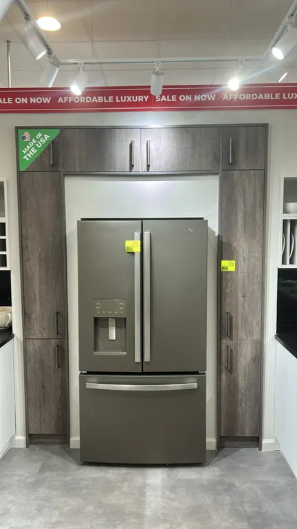 Infinity Plus refrigerator surround laminate cabinet. Features a wood-look laminate finish, two tall pantry columns with modern bar pulls, and an over