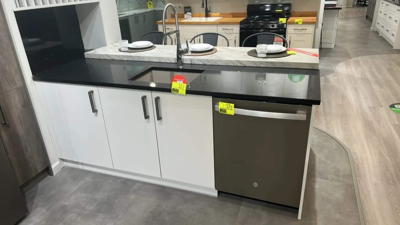 Infinity Plus kitchen island cabinet unit. Features white laminate base cabinets, black quartz countertop, Blanco undermount sink, and stainless steel