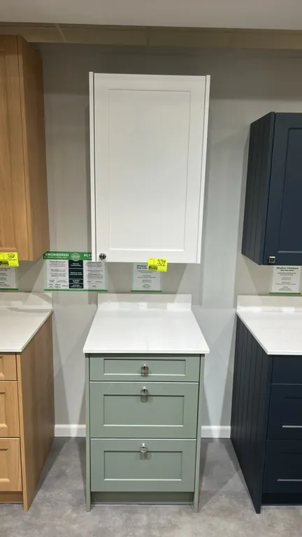 Infinity Plus Shaker cabinet set with quartz countertop. Includes white single-door upper wall cabinet and moss green 3-drawer base cabinet. Features