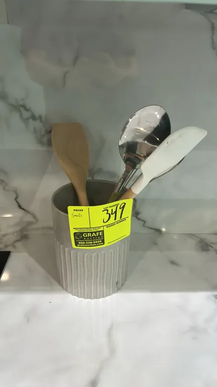 Assorted kitchen smallwares. Includes ceramic utensil crock with wooden spatula, silicone scraper, whisk, and metal spoon; (2) white fluted ceramic ra