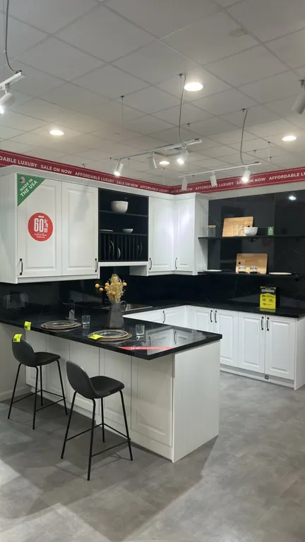 Infinity Plus laminate kitchen cabinet set with black marble-look laminate countertops. Includes stainless steel sink with pull-down faucet, upper and