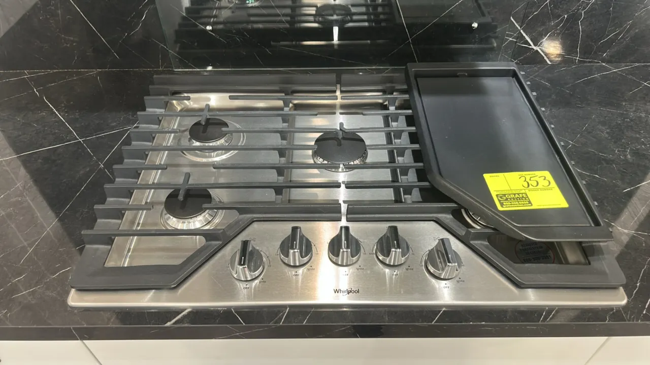 Whirlpool WCG97US0HS00 30" gas cooktop. Features stainless steel construction, 5 sealed burners, cast iron grates, and front control knobs. Includes g