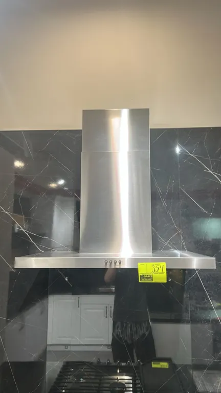 Whirlpool WVW57UC0FS3 wall-mount canopy range hood. Features stainless steel finish, push-button controls, integrated lighting, and telescoping chimne